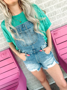 Medium wash distressed overalls