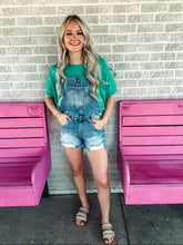 Load image into Gallery viewer, Medium wash distressed overalls
